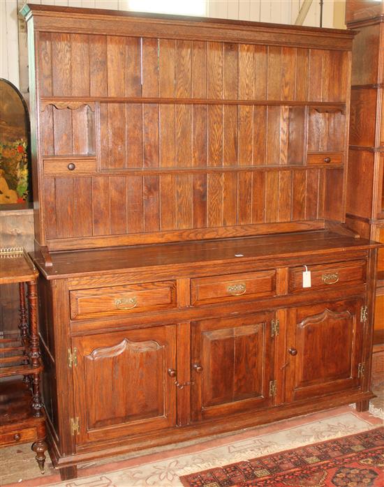 Reproduction oak dresser with three drawers and panelled doors